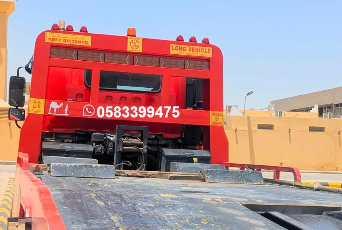 Habib Satha Towing red flatbed truck in Riyadh