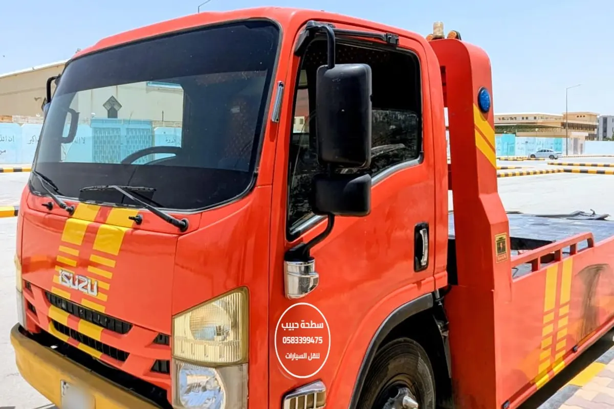 Habib Satha Towing red flatbed truck in Riyadh