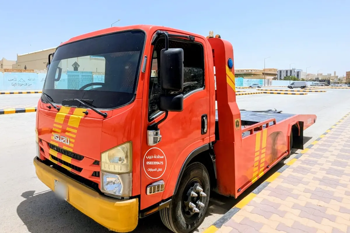Habib Satha Towing red flatbed truck in Riyadh